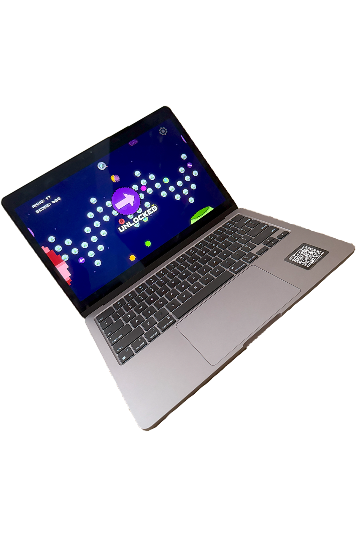 Laptop showing a pixel-art game with an unlocked level